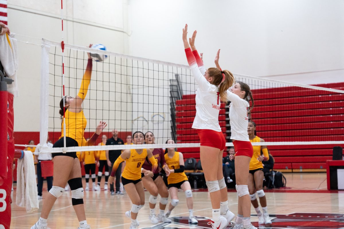 Tana Long (left) and Katie McArthur (right) jump to block a ball smashed by Brianna Galvan in the game against Pasadena City on Sept. 18 at the Sports Pavilion at City College in Santa Barbara, Calif. The Vaqueros won the game 3-1.