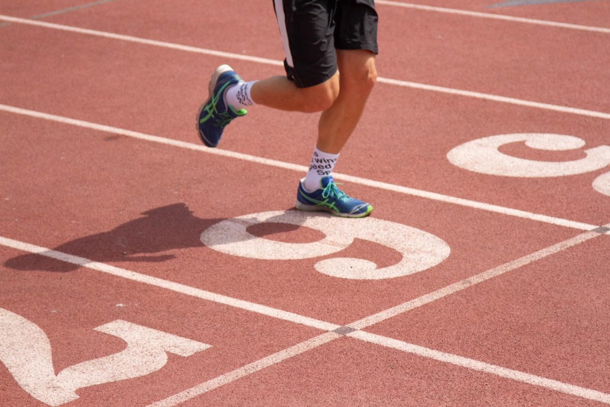 Photo illustration of runner on La Playa Stadium track.