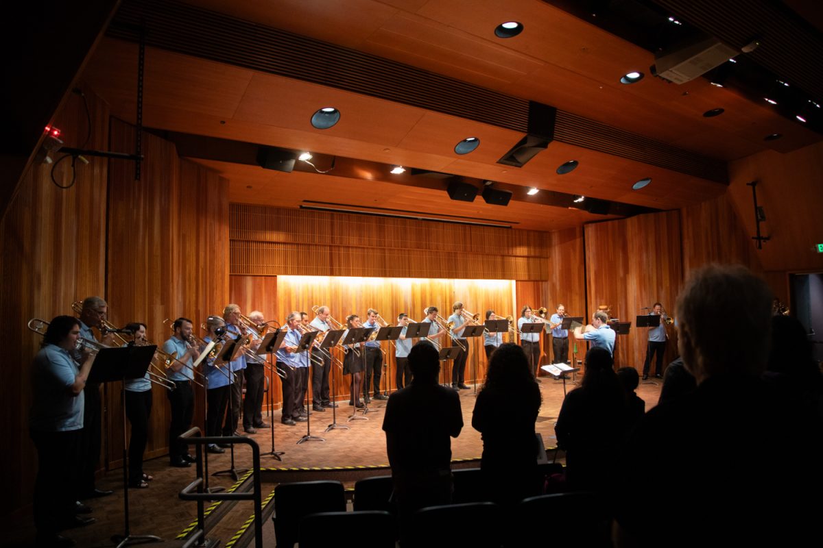 Audience members rise as the City College Trombone Choir performs the national anthem at their SlideShow event on Oct. 26 at the Fe Bland Forum on West Campus.