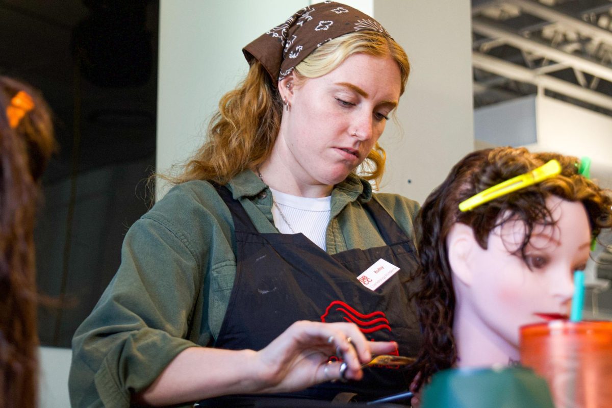 Bailey Pike trims the hair of a practice doll on Nov. 21 at the SBCC Cosmetology Academy in Santa Barbara, Calif. "I think that it's a great opportunity for people to branch out into their creative side," Pike said.