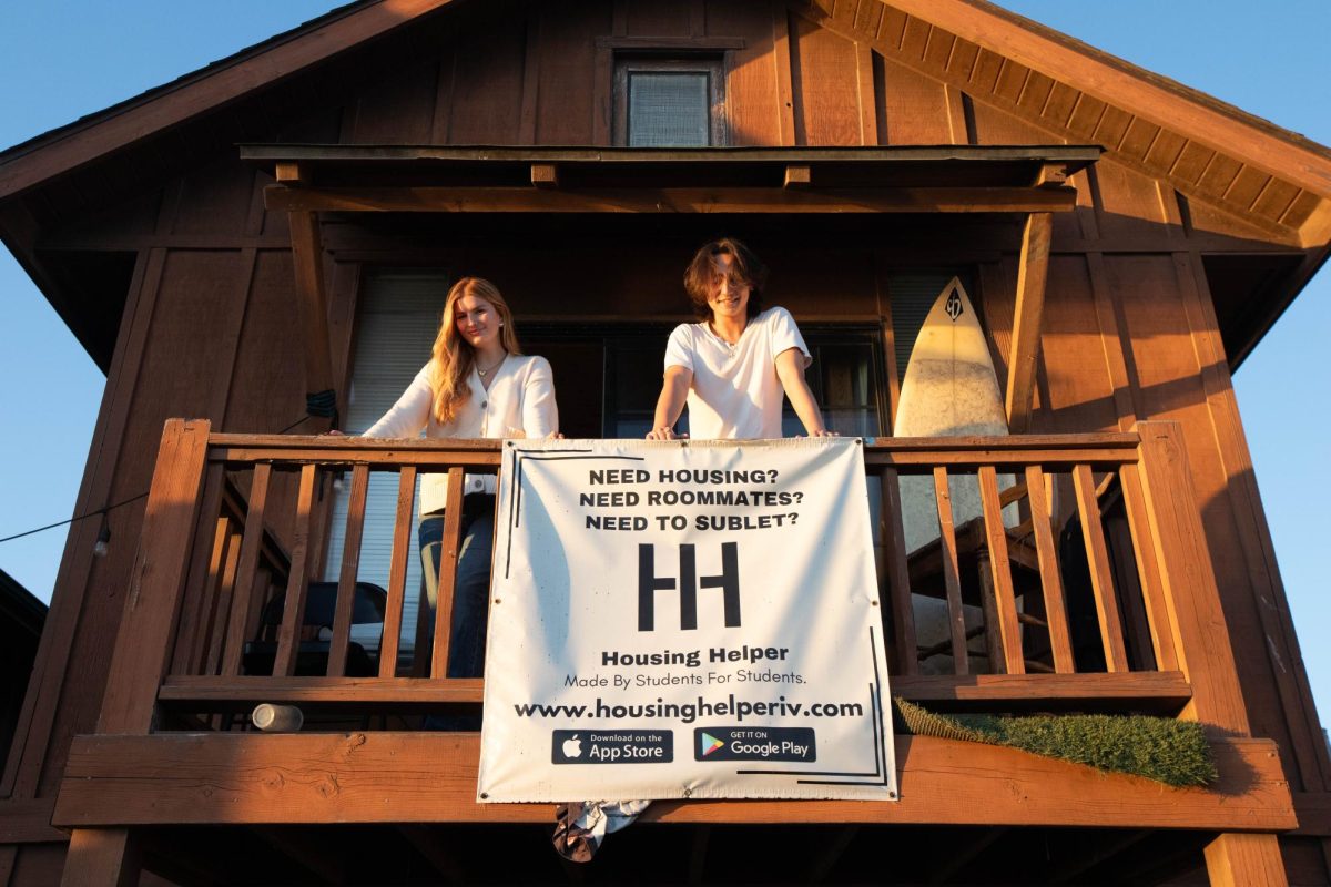 Mason Watters (left) and Damon Dvorson (right) stand at the balcony of the Sigma Chi Satellite house where Dvorson's office is held on Oct. 30 in Isla Vista, Calif. The two began working together in summer 2024.