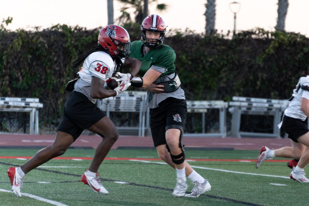 Will Doherty tries to steal a ball from his teammate Derrian Brown during football practice on Nov. 14 at La Playa Stadium at City College in Santa Barbara, Calif. During football season, Doherty practices daily from Monday to Friday.